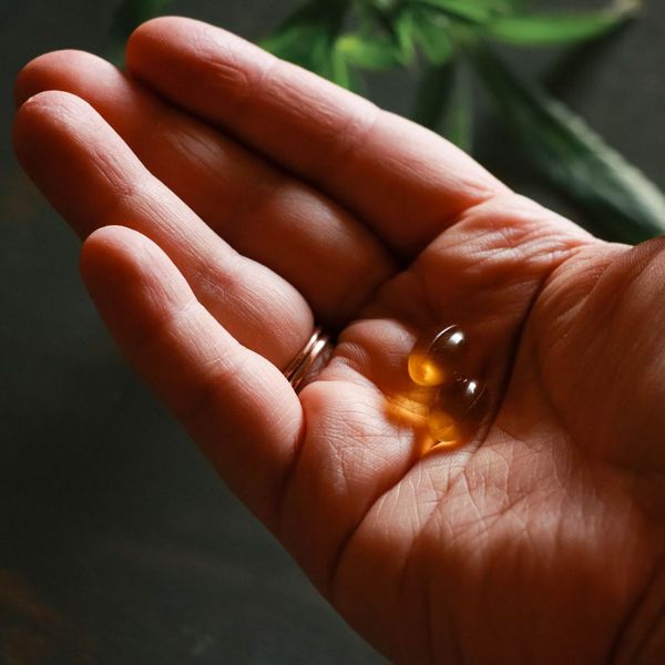 a person taking two supplement capsules Tips for Choosing Natural Supplements (3).jpg