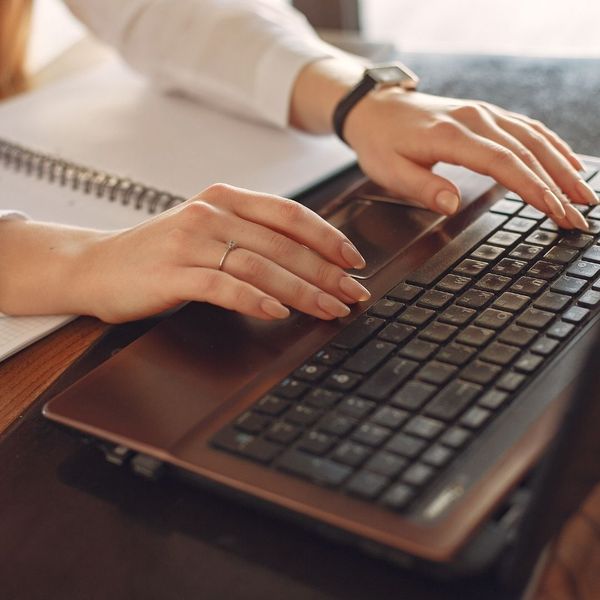 Typing on a laptop