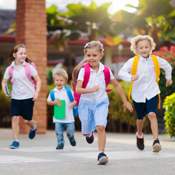 kids with backpacks running.