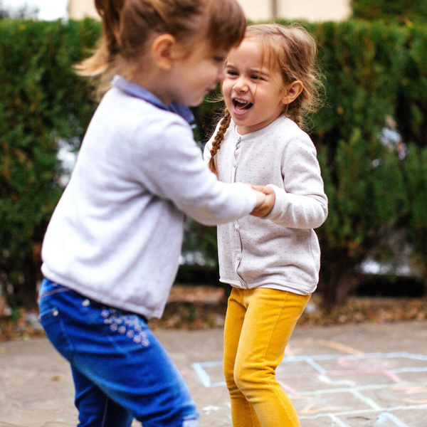 Two little girls playing outside