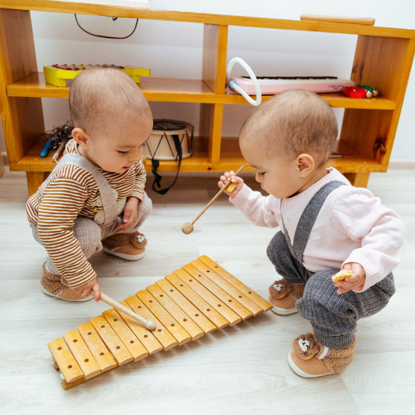 children playing on a wooden xylophone together