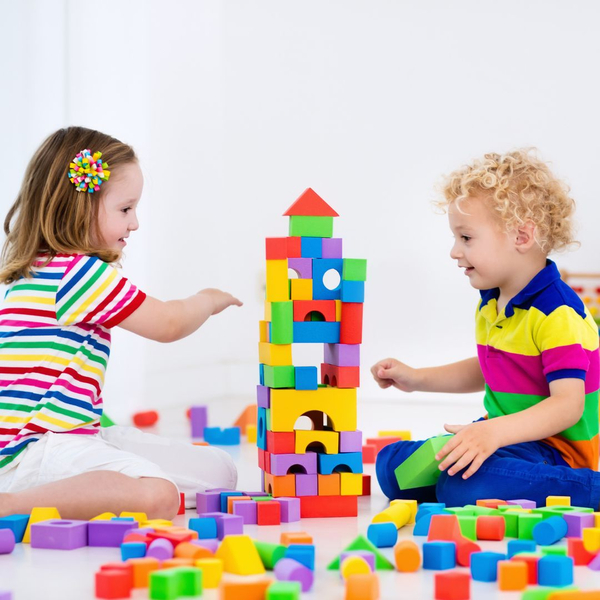 children building together with blocks