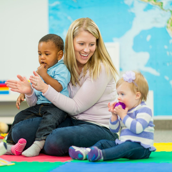 child care worker with infants at daycare