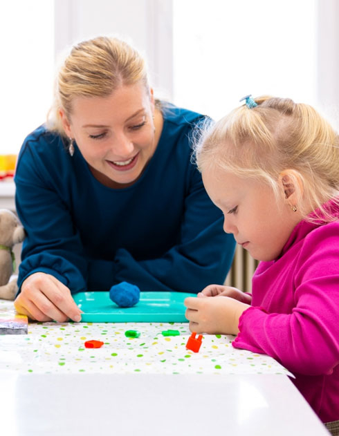 Teacher teaching young student