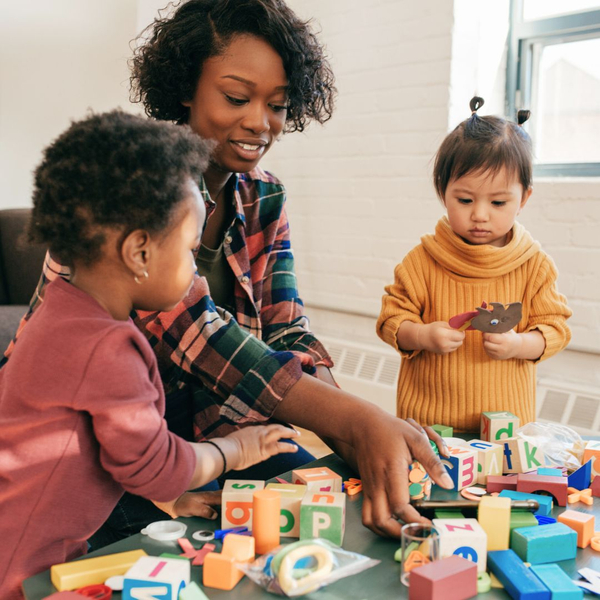 kids playing with blocks with daycare teacher