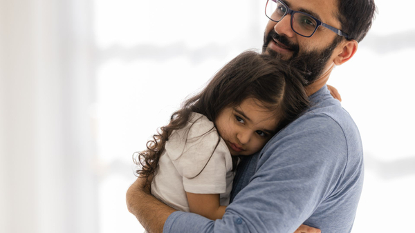 dad holding daughter