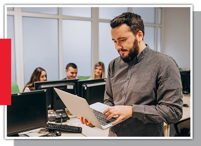 Image of a man looking at a laptop