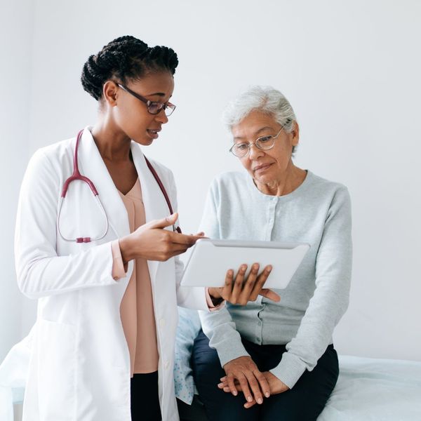 Female doctor and patient having a consultation looking at a tablet