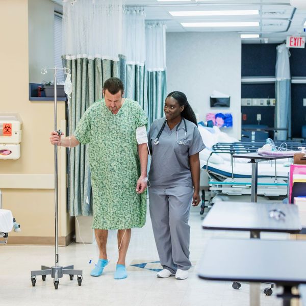 Healthcare worker focused on patient.