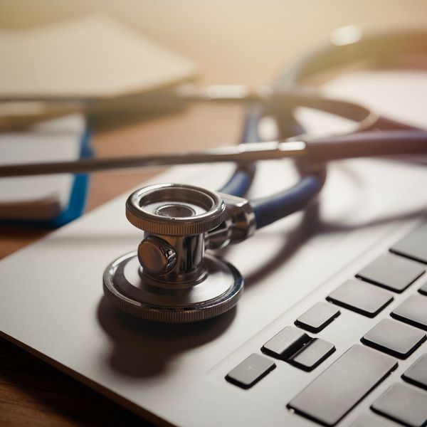 stethoscope sitting on a laptop keyboard