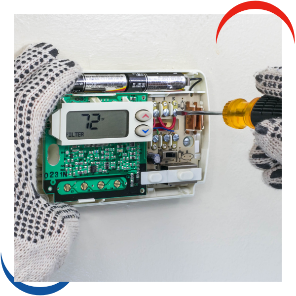 tech working on thermostat