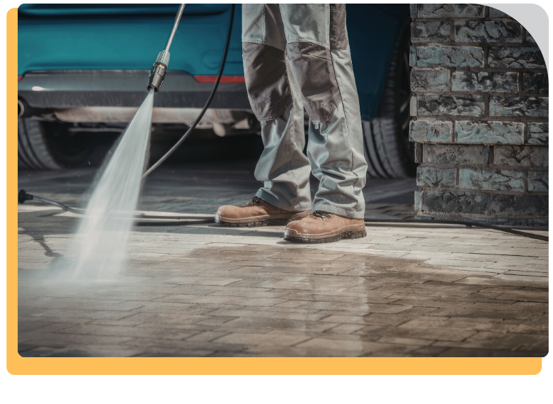 a man pressure washing stone