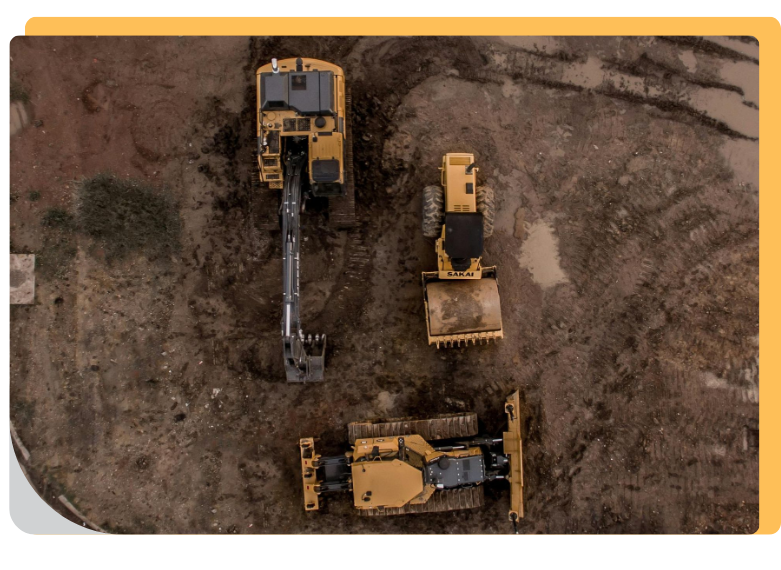 aerial view of 3 different types of bulldozer machines