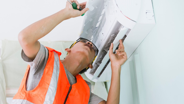 technician performing maintenance on mini split