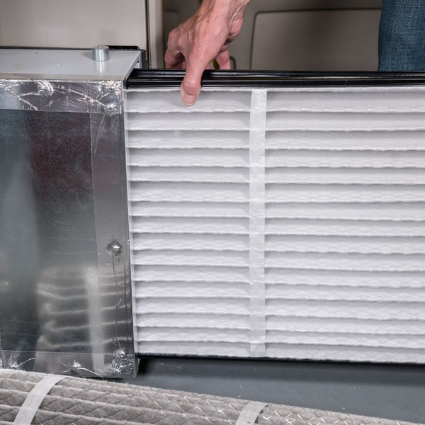 person replacing an air filter person replacing an air filter