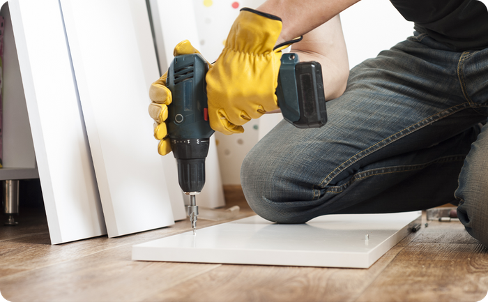 Handyman drilling furniture pieces