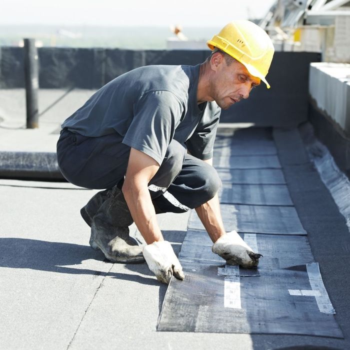 roof technician servicing flat roof
