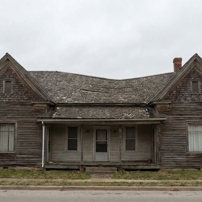 An old house with a noticeably sagging roofline.