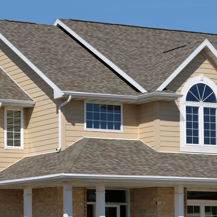 A yellow home with a new roof