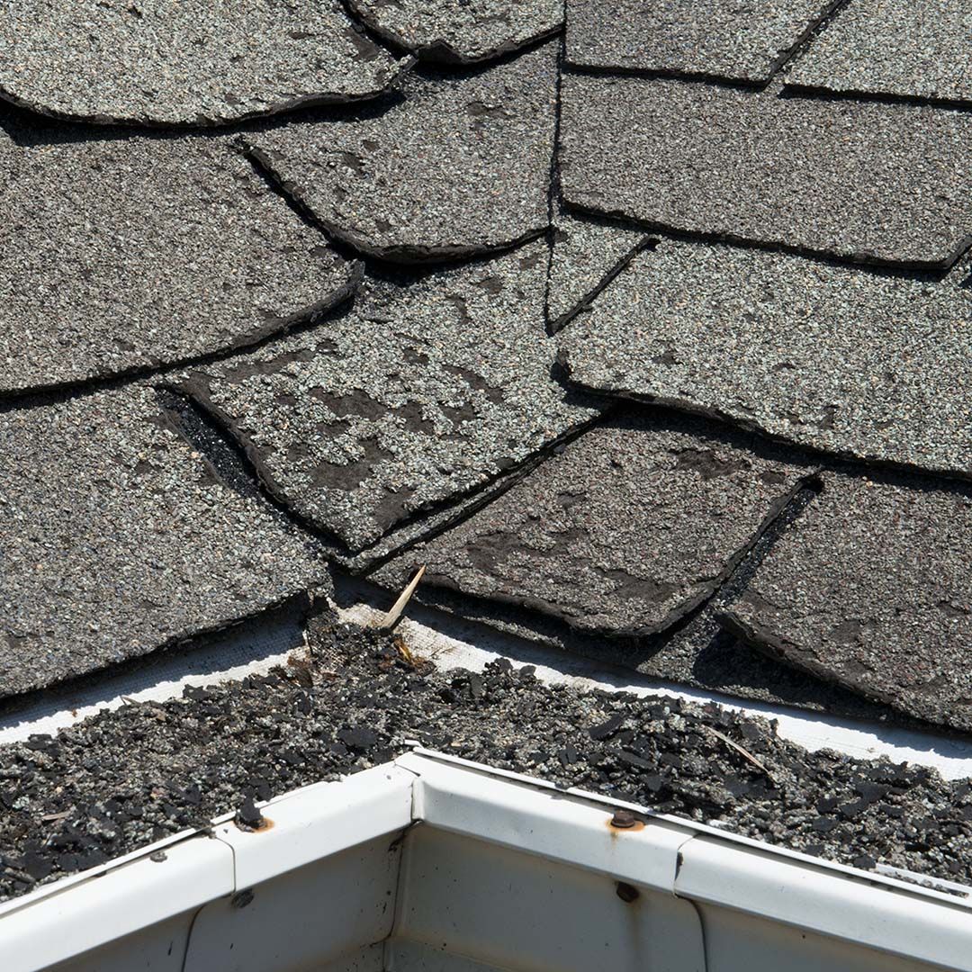 Image of a man inspecting a roof