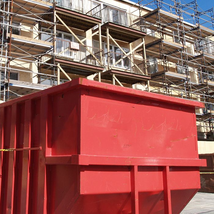 Image of a large dumpster outside of a construction site