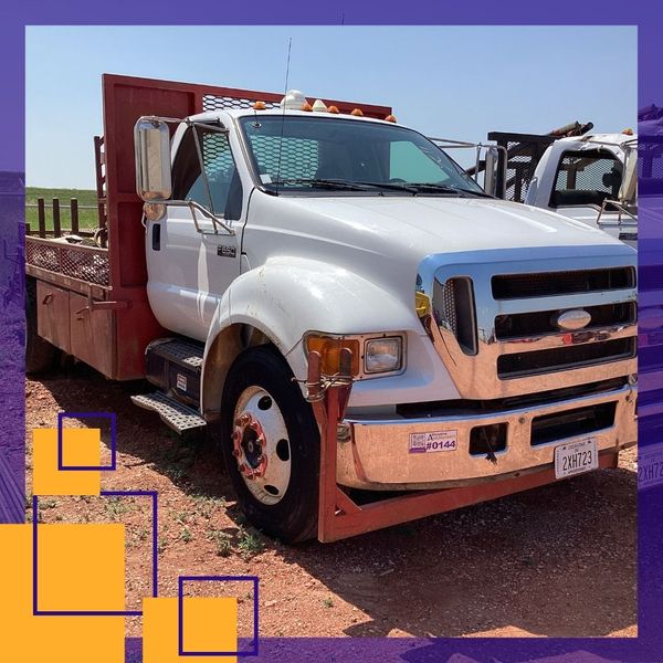 White truck with a red bed for equipment transportation 