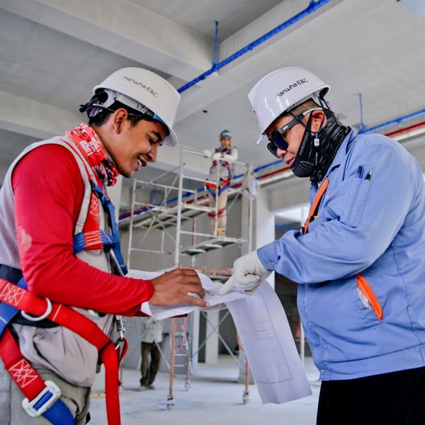 construction workers looking at plans