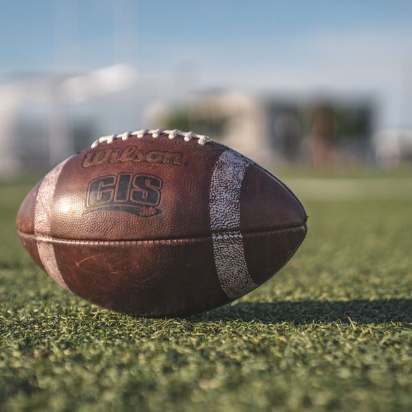 Football on grass field, close-up