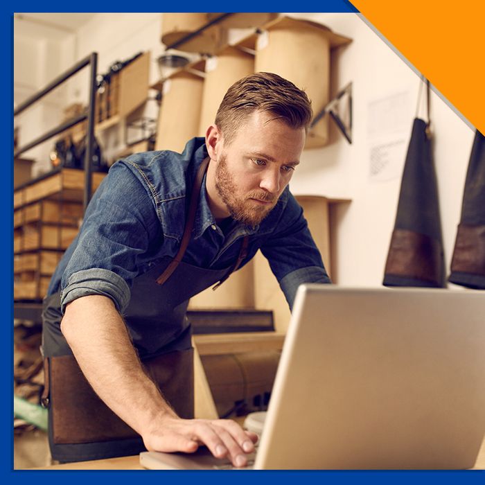 man working at the desk of his warehouse