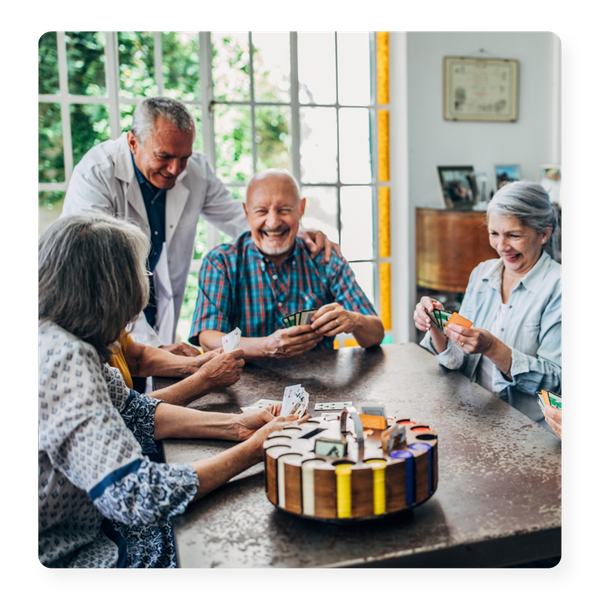 A group of seniors in a nursing home enjoying a card game