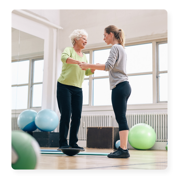 A senior woman doing physical therapy with a physical therapist