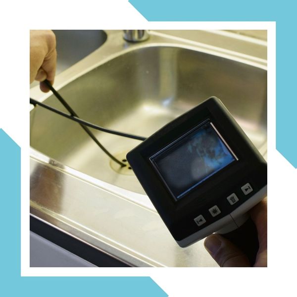 plumber uses a drain camera to find clog in the sewer line Sewer Cleaning 1.jpg