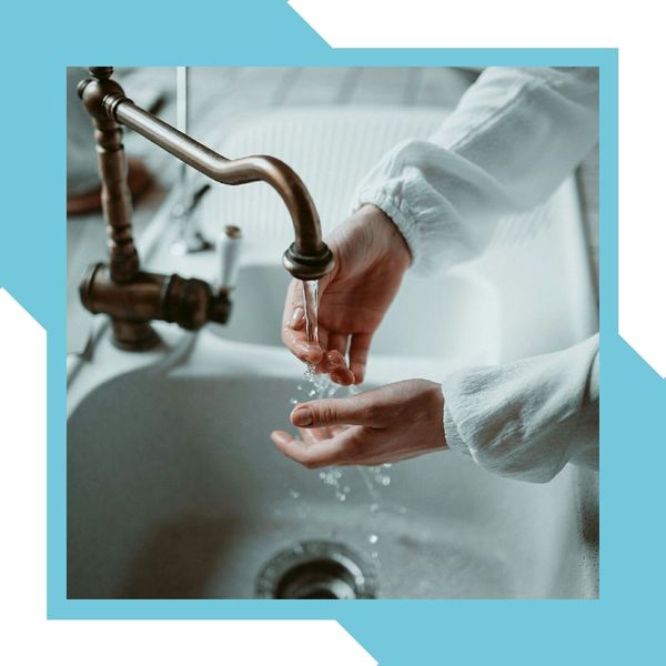 person washing hands in kitchen sink Sewer Cleaning 4.jpg