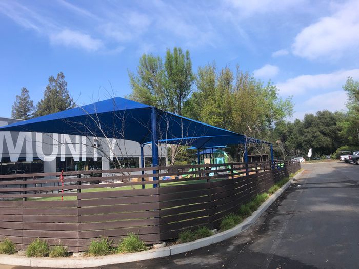 A rectangular shade for an outdoor kids park
