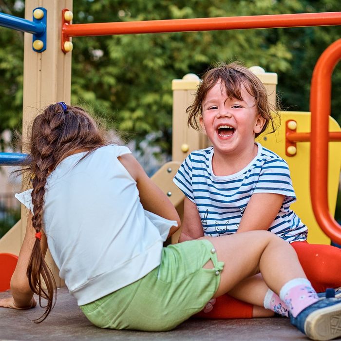 kids laughing and playing on playground