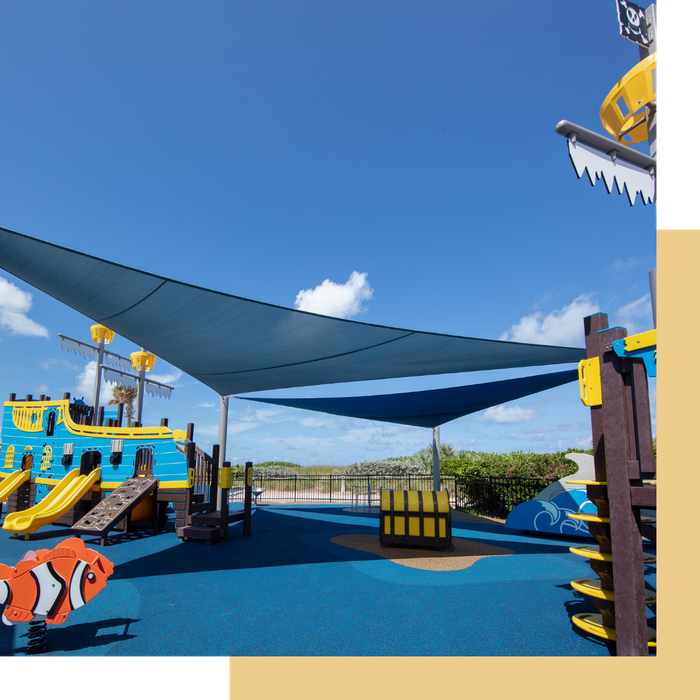 Durable playground shade structures protecting seamless poured-in-place rubber safety surfacing from the sun.