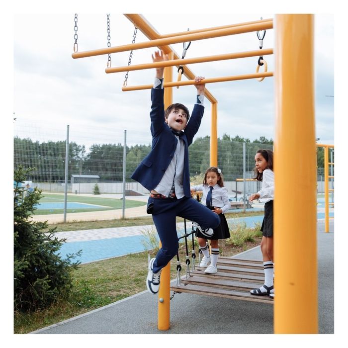 boy using monkey bars