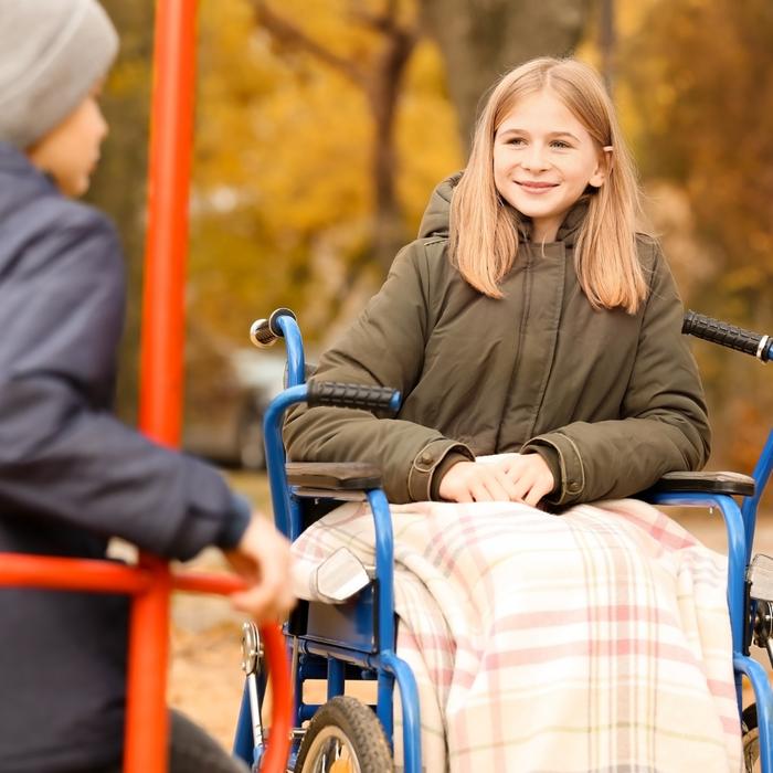 girl in a wheelchair on a playground. 