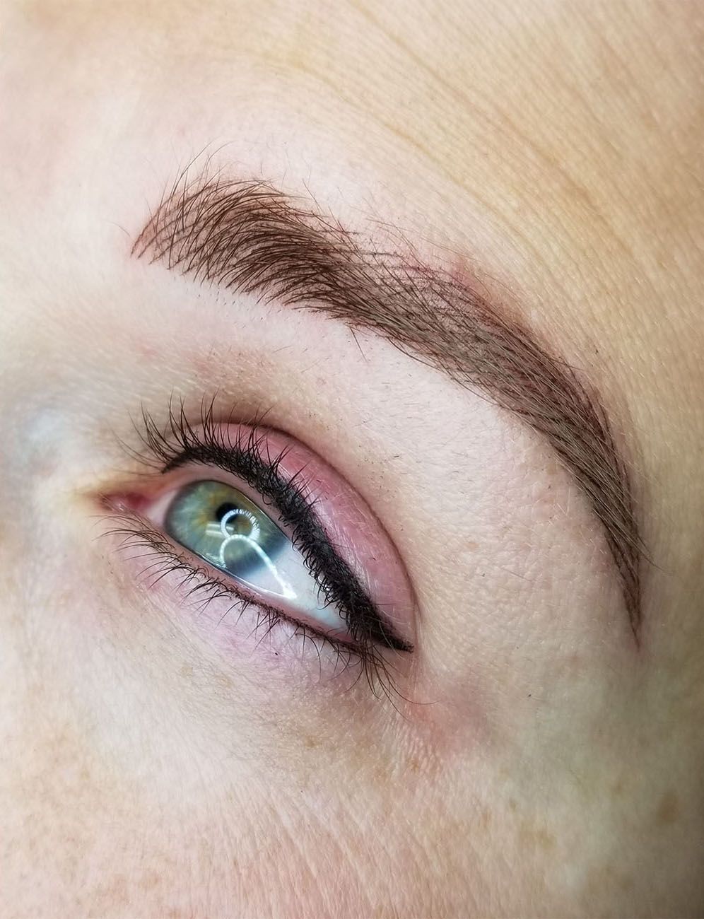 eye with permanent makeup applied