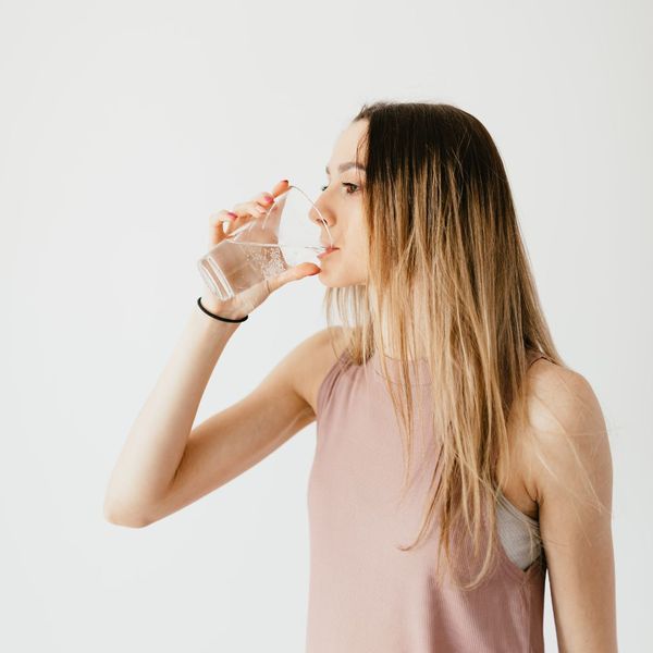 woman drinking water from a glass