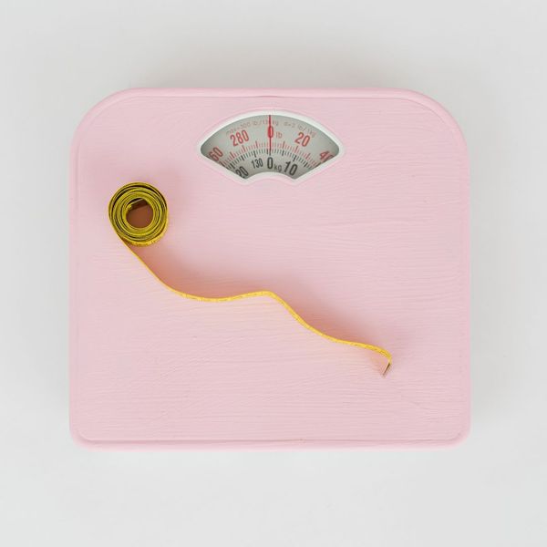 Pink scale and a measuring tape Pink scale and a measuring tape