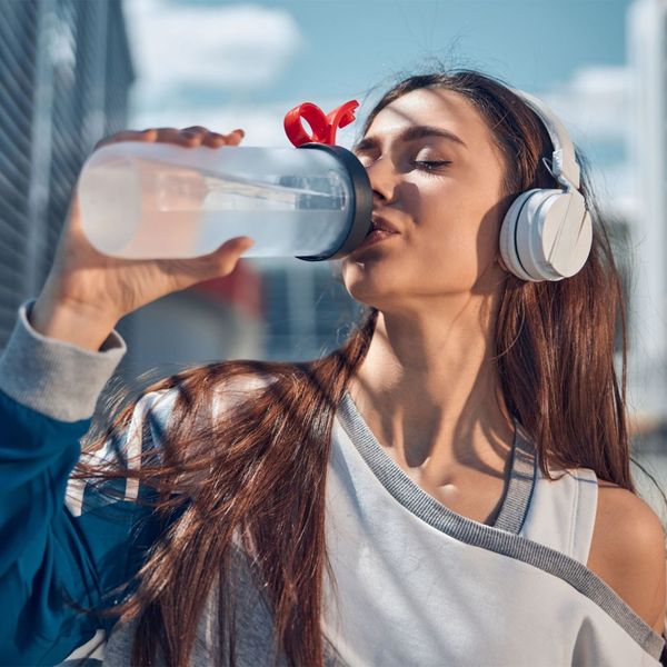 Woman drinking from her water bottle Woman drinking from her water bottle