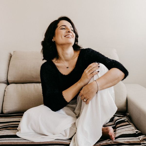 thin woman sitting on couch