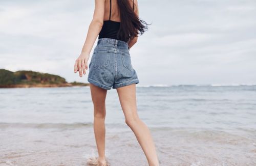 woman walking along beach