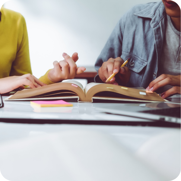 Student and teacher studying a book