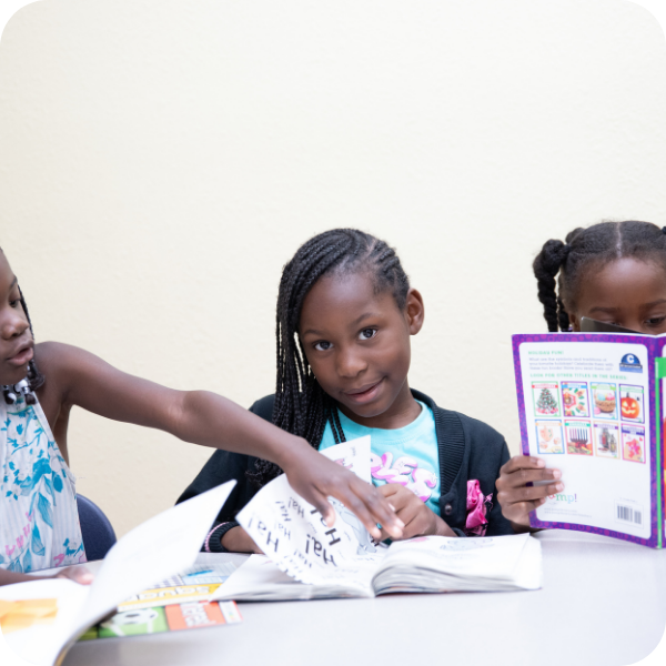 Three girls reading together