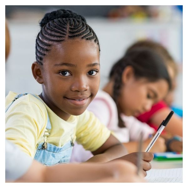 girl looking up in class from assignment