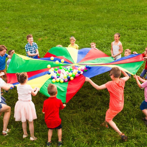 Children playing with a large umbrella