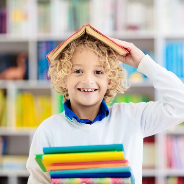 child smiling with books