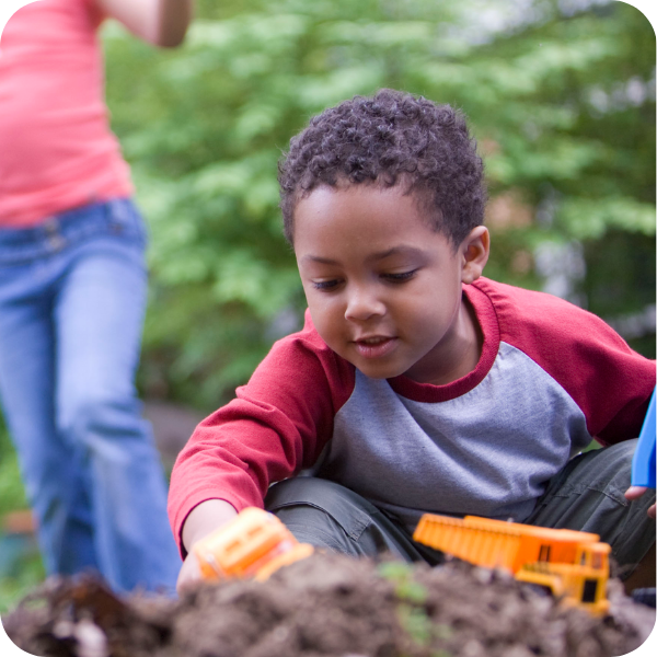 Boy playing with toys outside